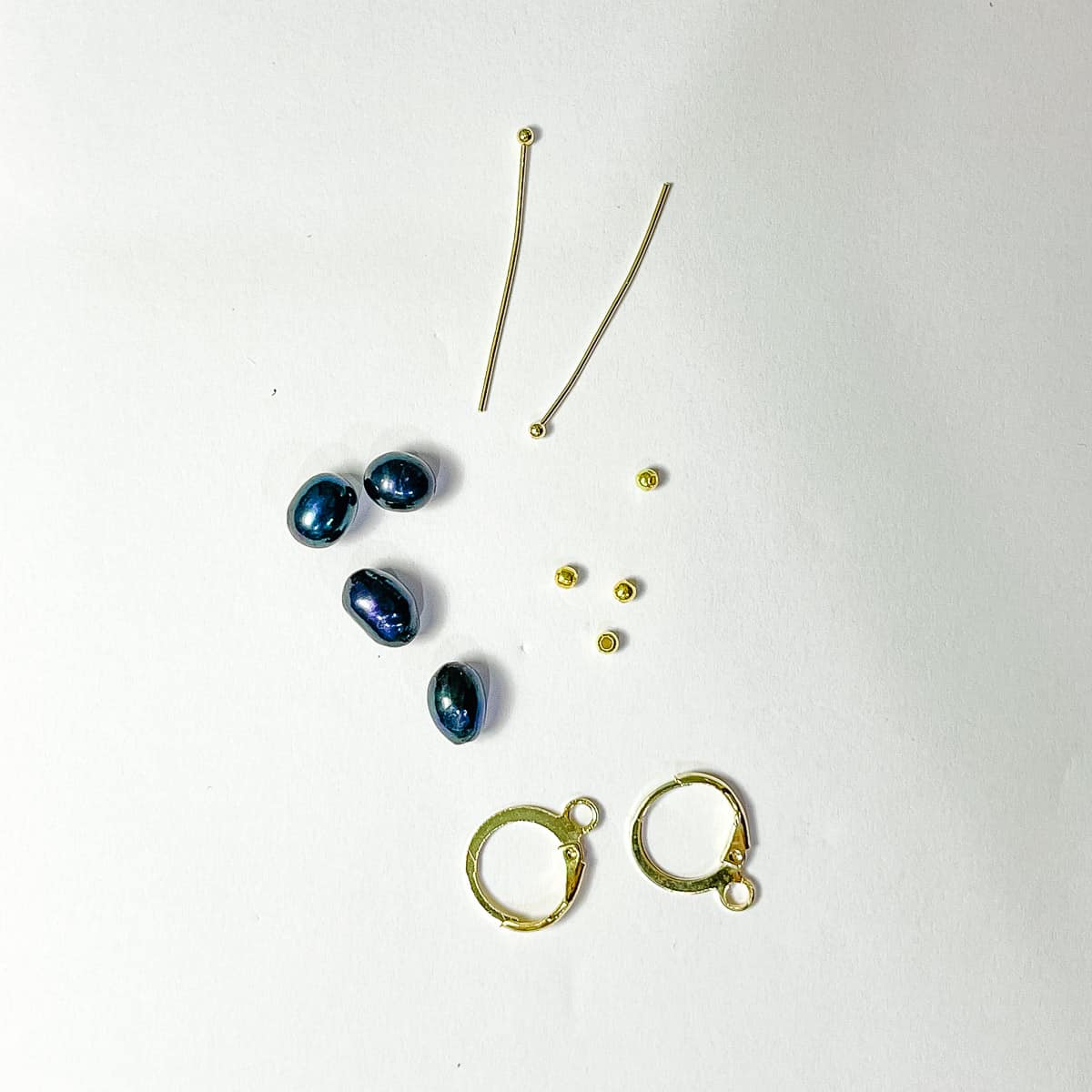 4 blue pearls, 2 headpins, 4 gold filler beads and 2 gold lever back earring hoops.