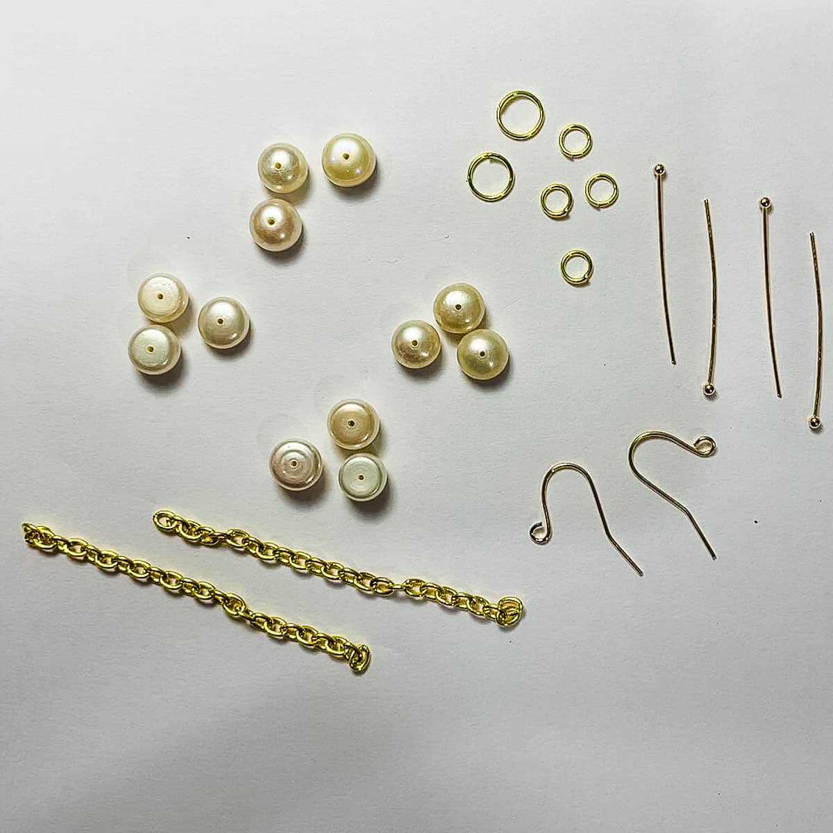 Freshwater pearls, headpins, jump rings, earring hooks and gold link chains.