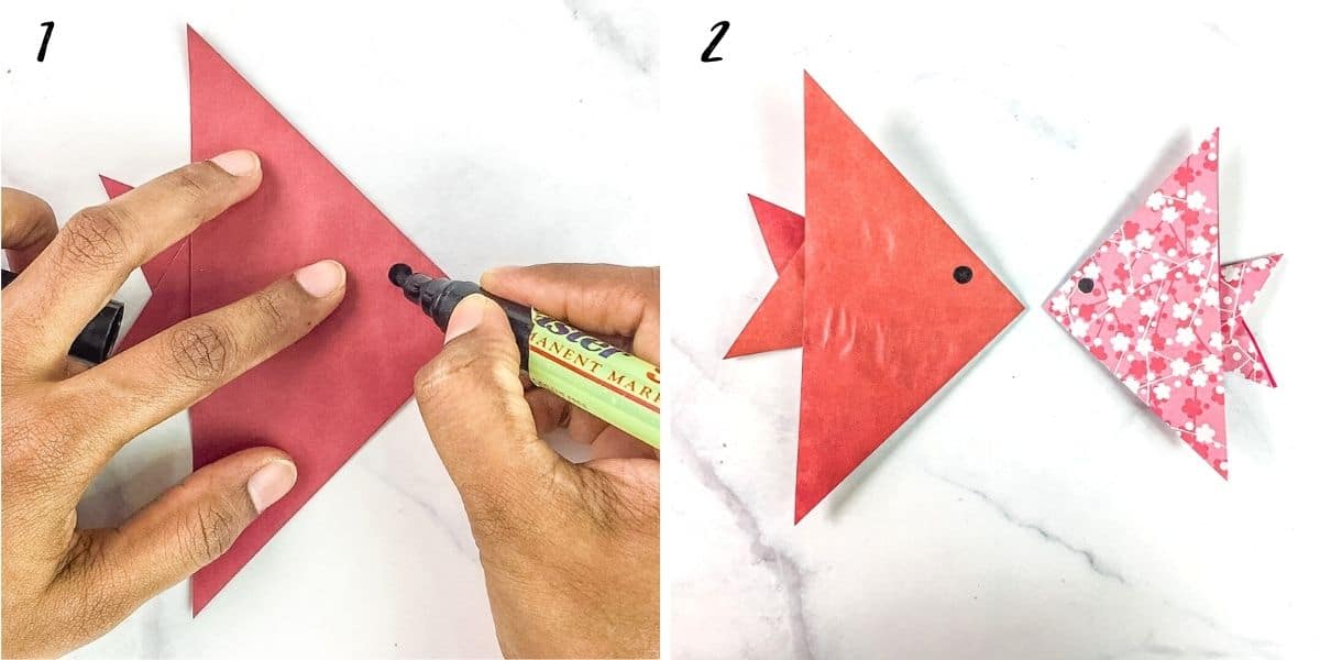 Use a black marker to mark the eyes on a paper fish.