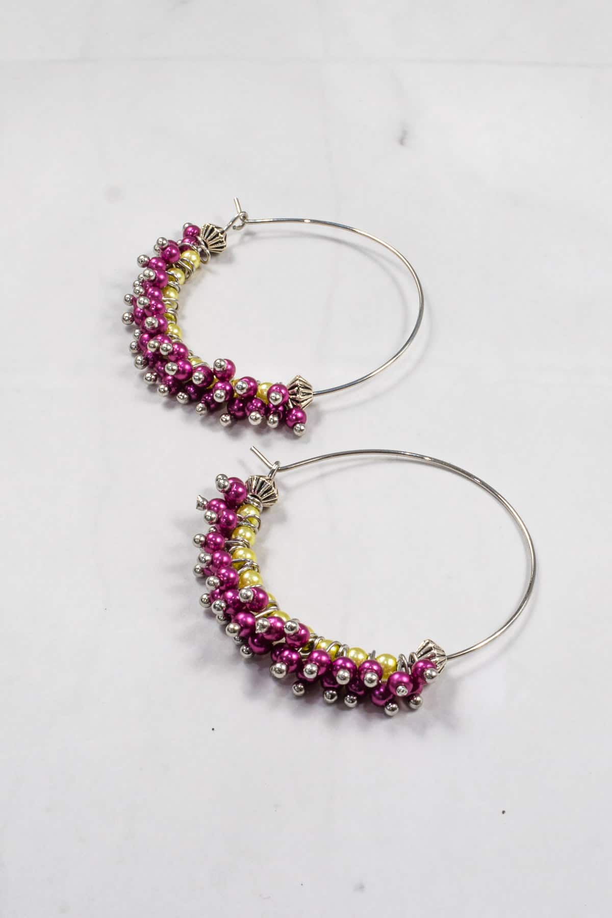 Seed bead earrings in purple and green.