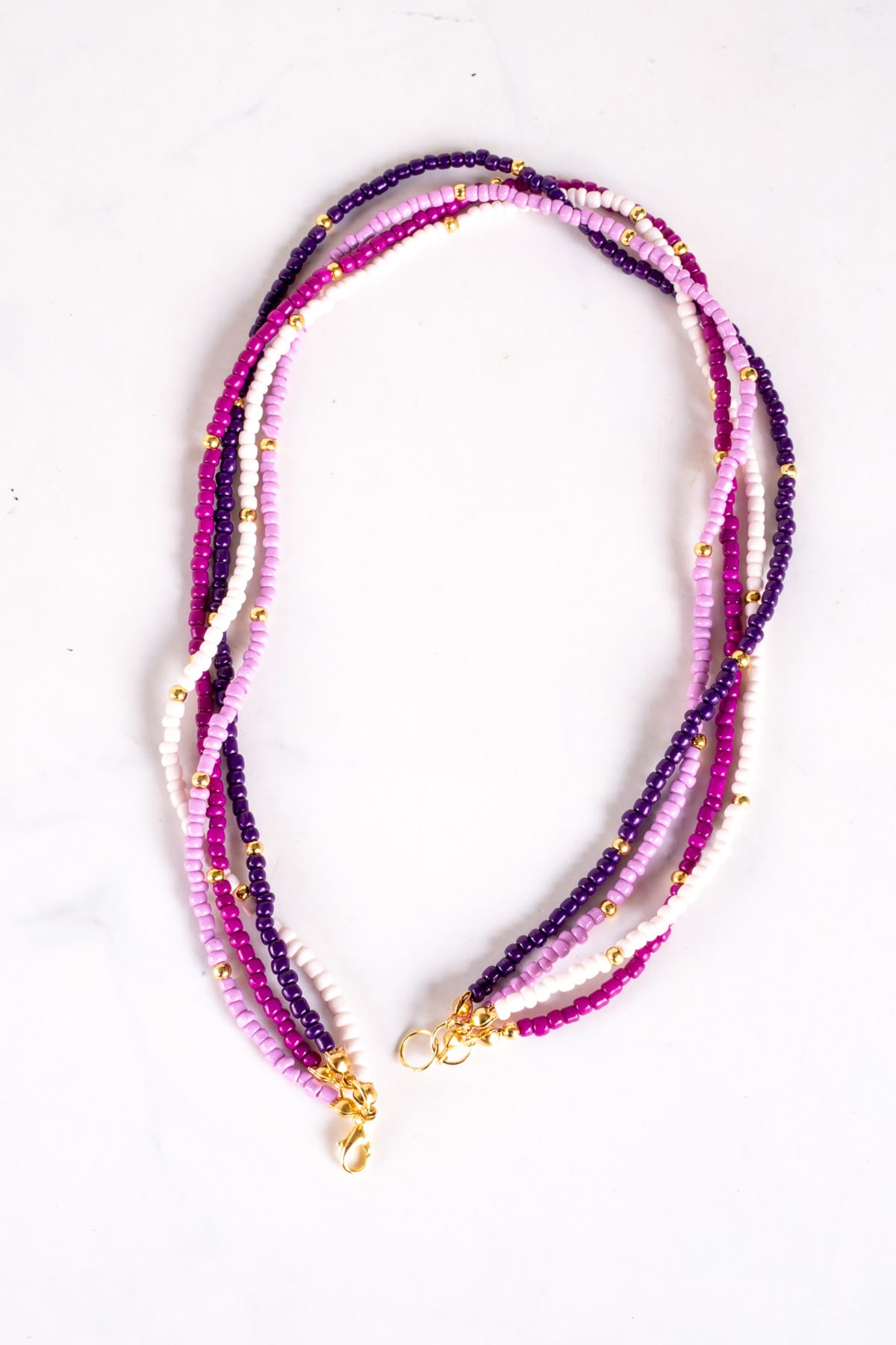 Seed bead necklace in purple and gold.