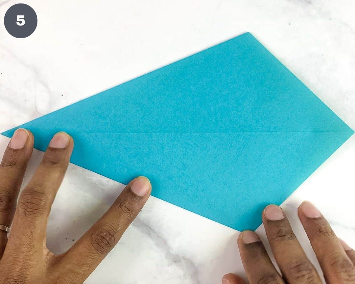 Folding a blue paper.