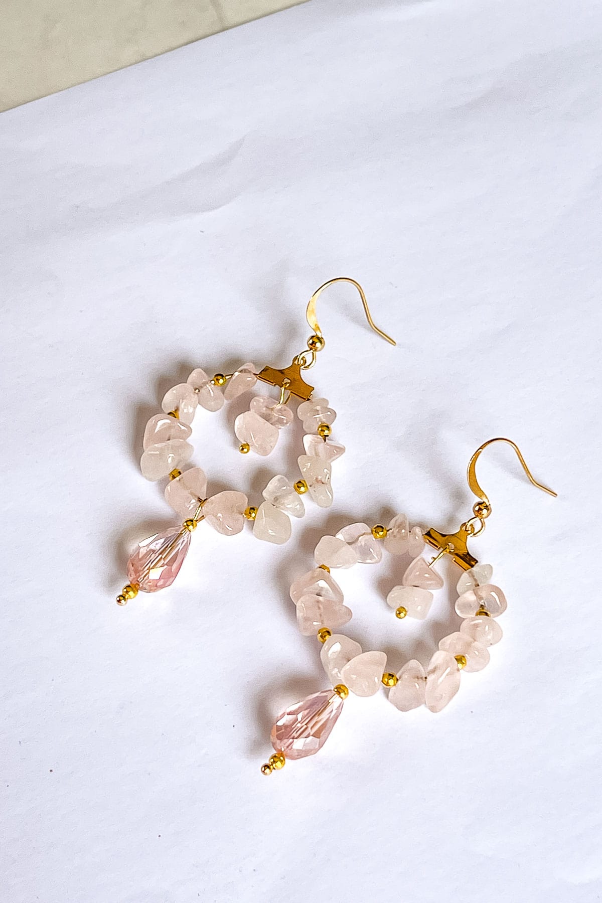 A pair of pink quartz beaded hoop earrings.