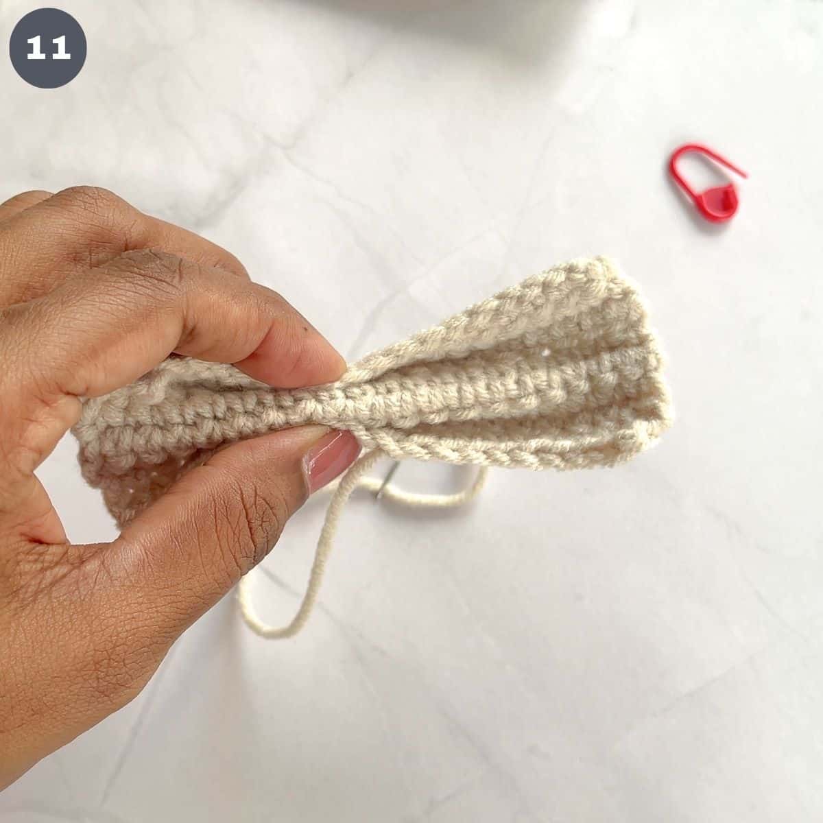 Holding the center of a crochet bow.