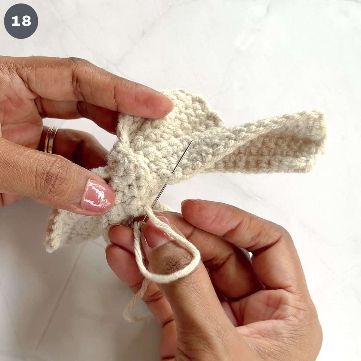 Stitching a crochet bow tails together.
