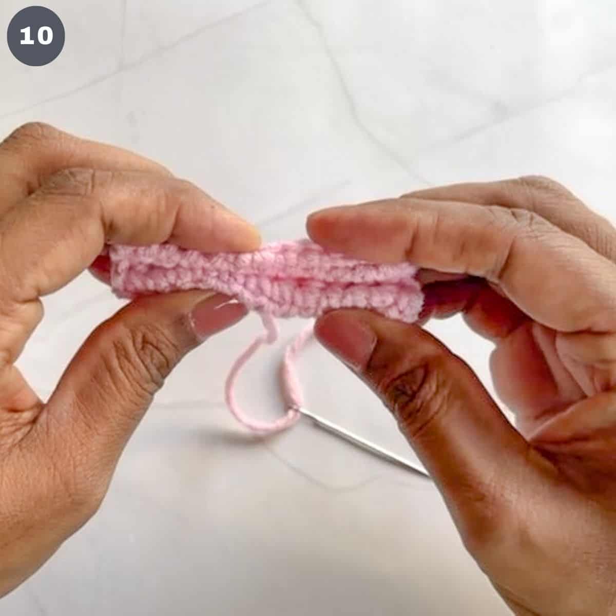 Folding a rectangle crochet piece into a 'w' shape.