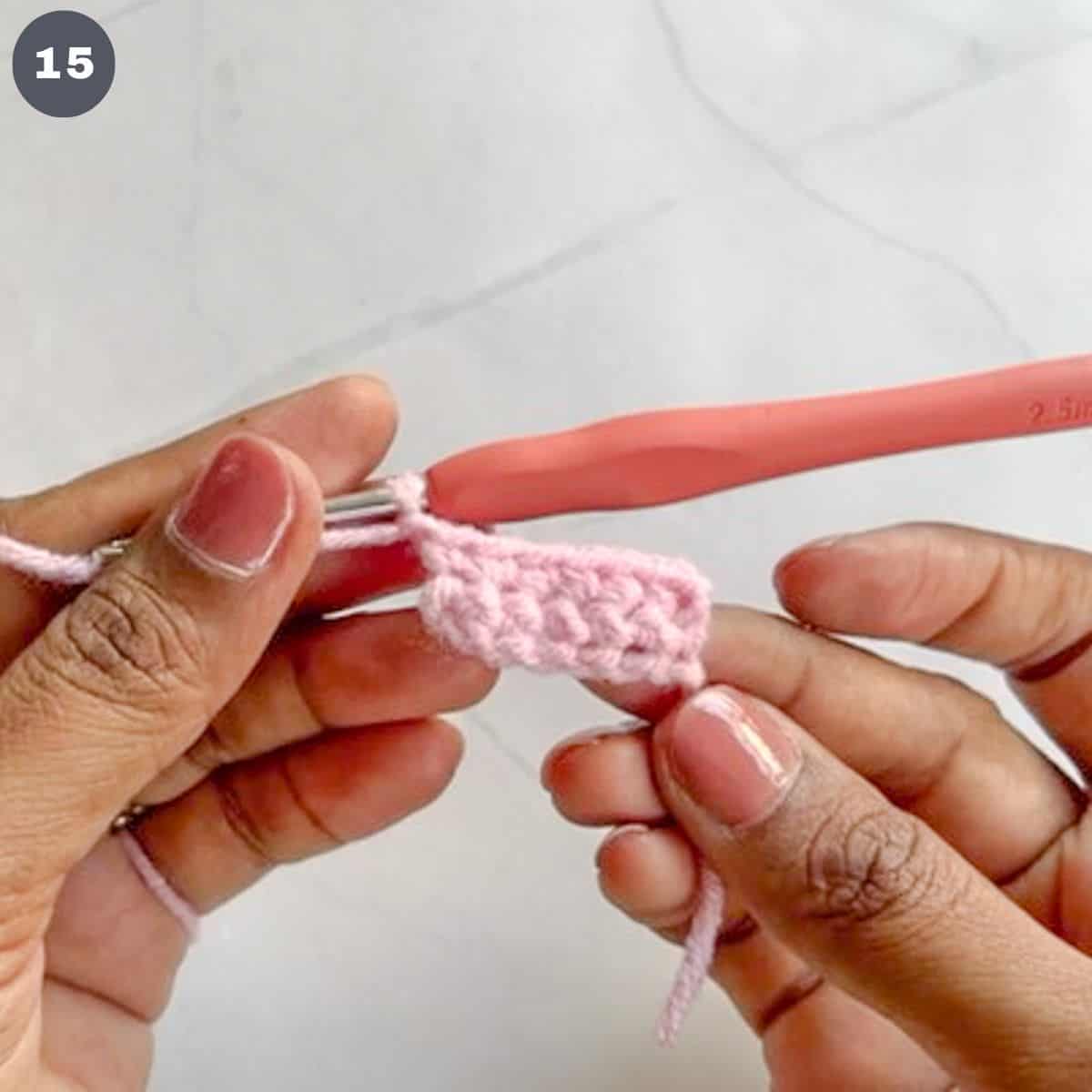 A rectangle crochet piece in pink yarn.