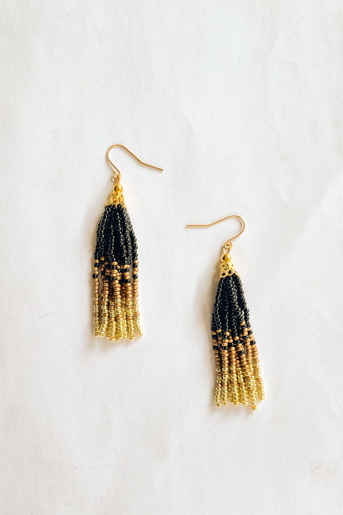 A pair of black, bronze and gold beaded tassel earrings.