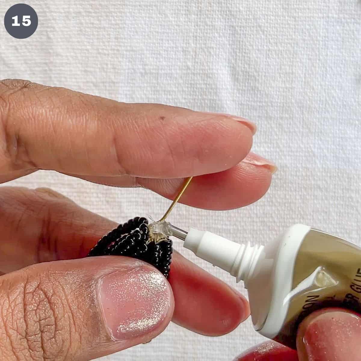 Applying glue to an eye pin.