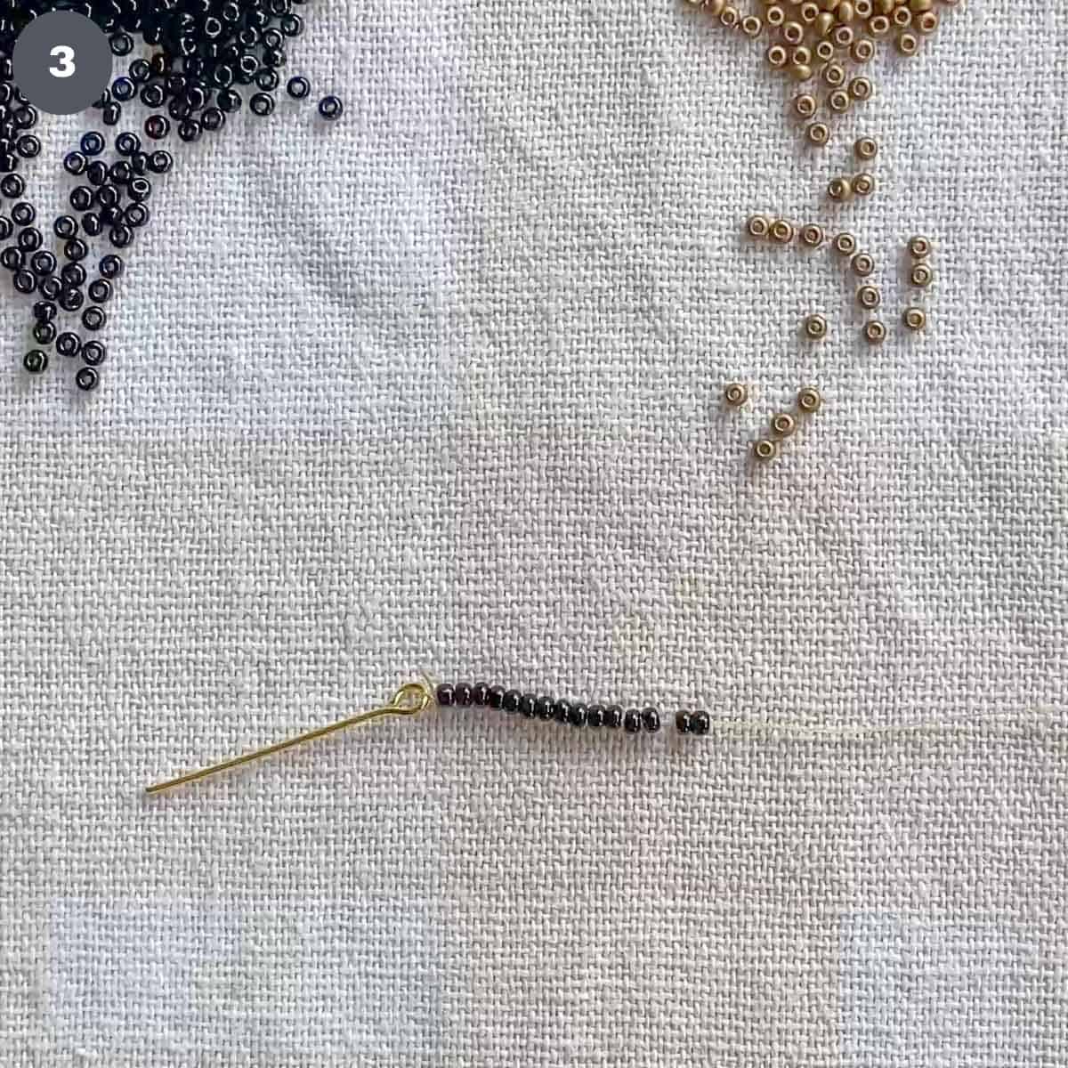 A strand of black seed beads attached to an eye pin.