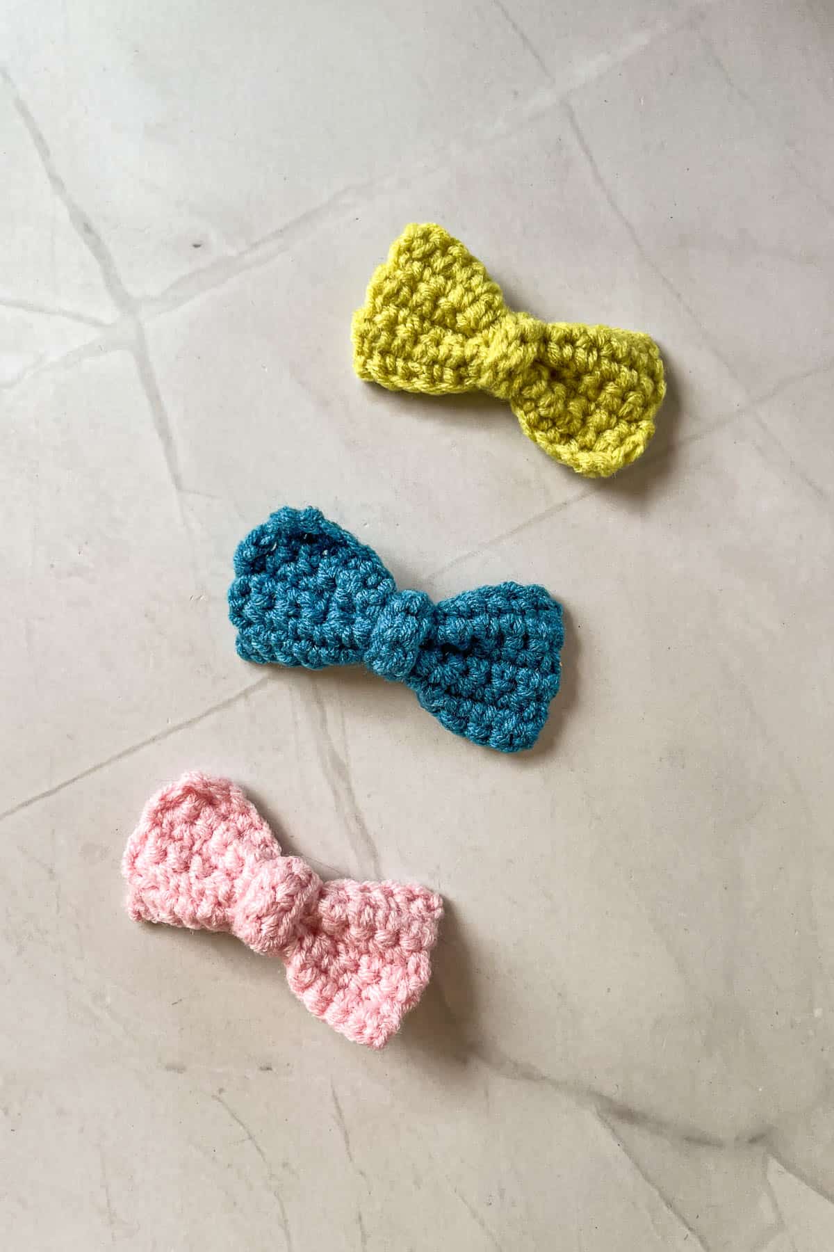 Blue, pink and green crochet bows.