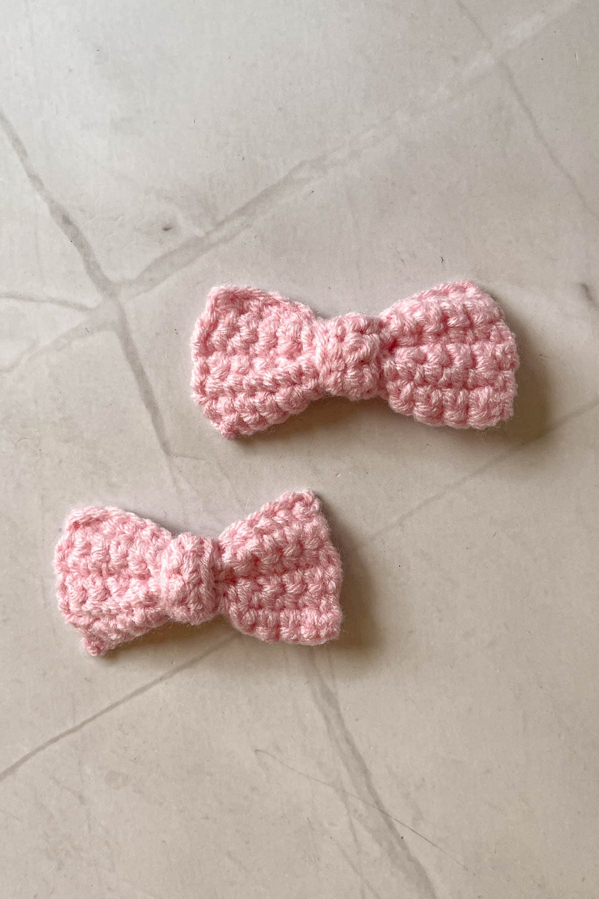 2 pink crochet bows.