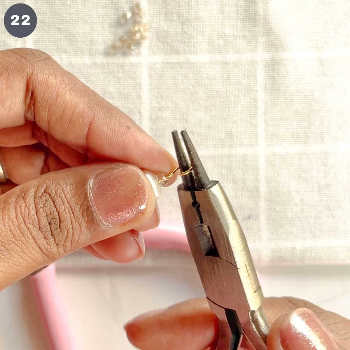 Making a loop at the end of an eye pin with pliers.