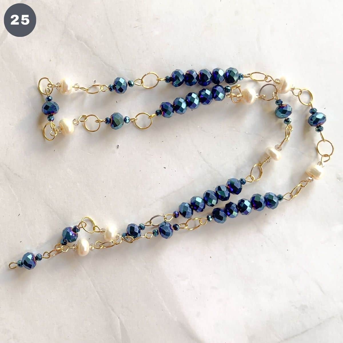 A stand of bead necklace in blue and white.
