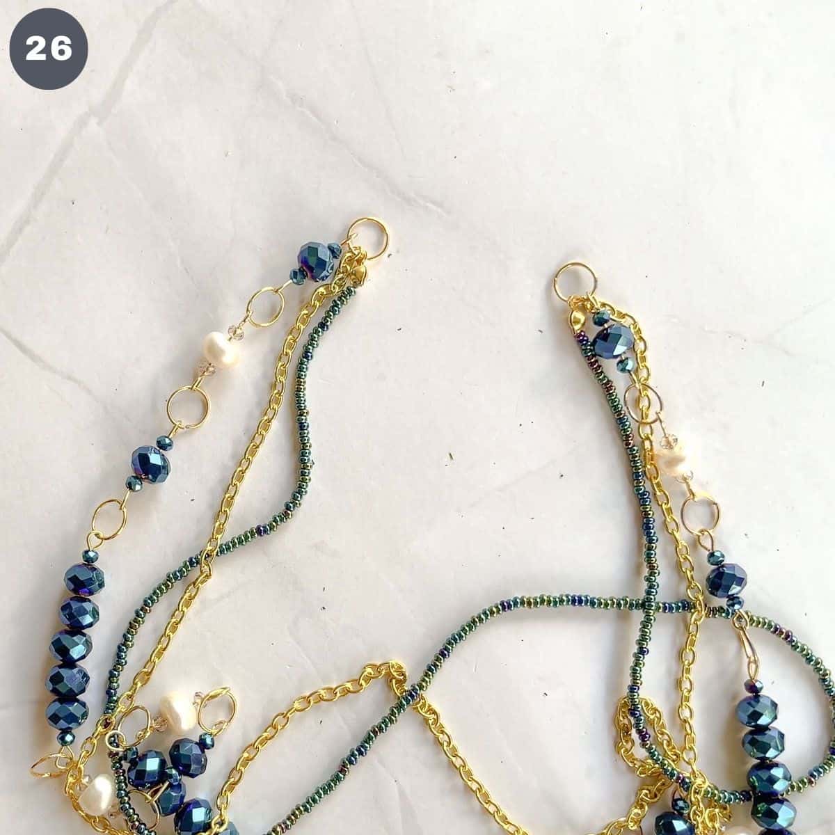Jump rings at both ends of a multi layer necklace.