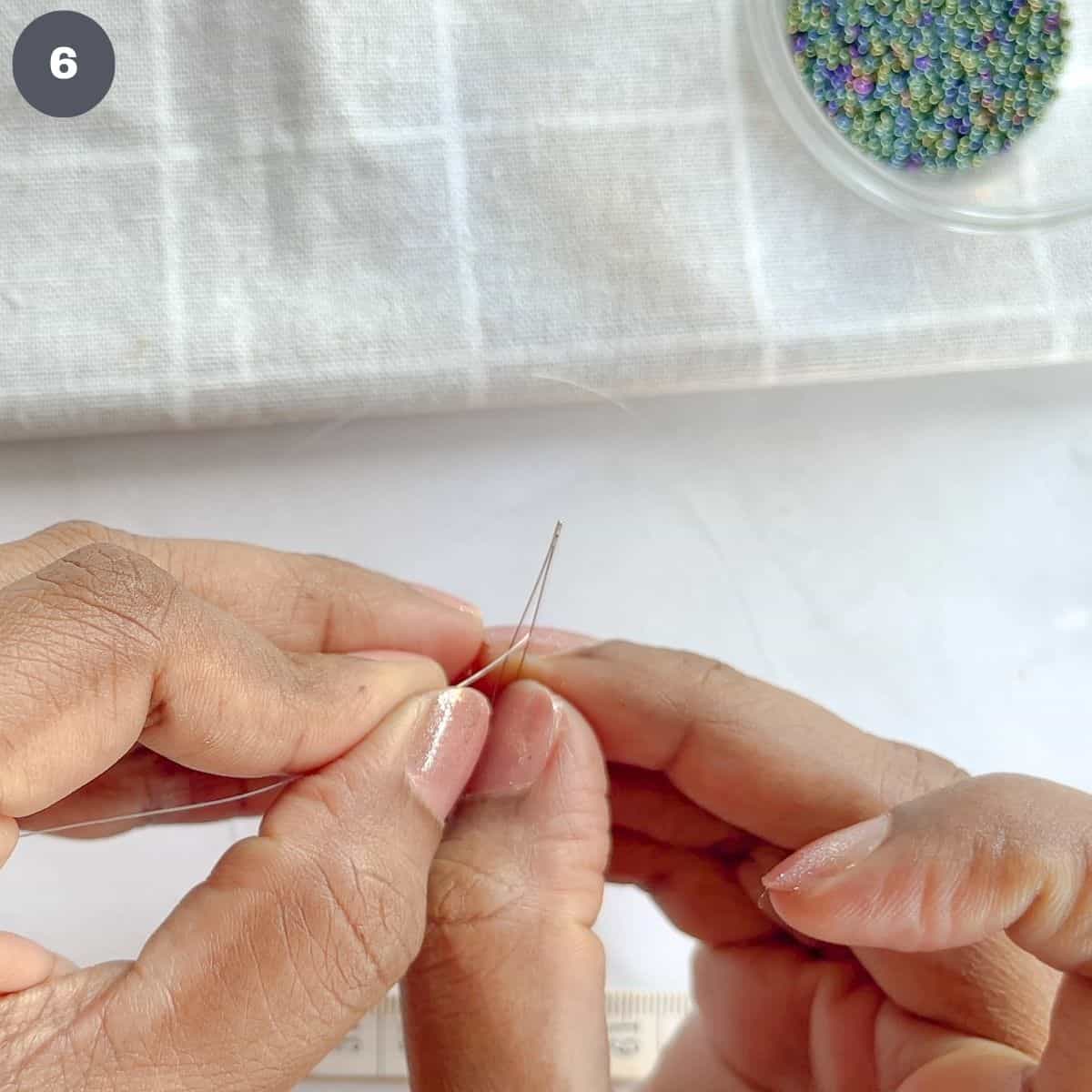 Inserting thread into a needle.