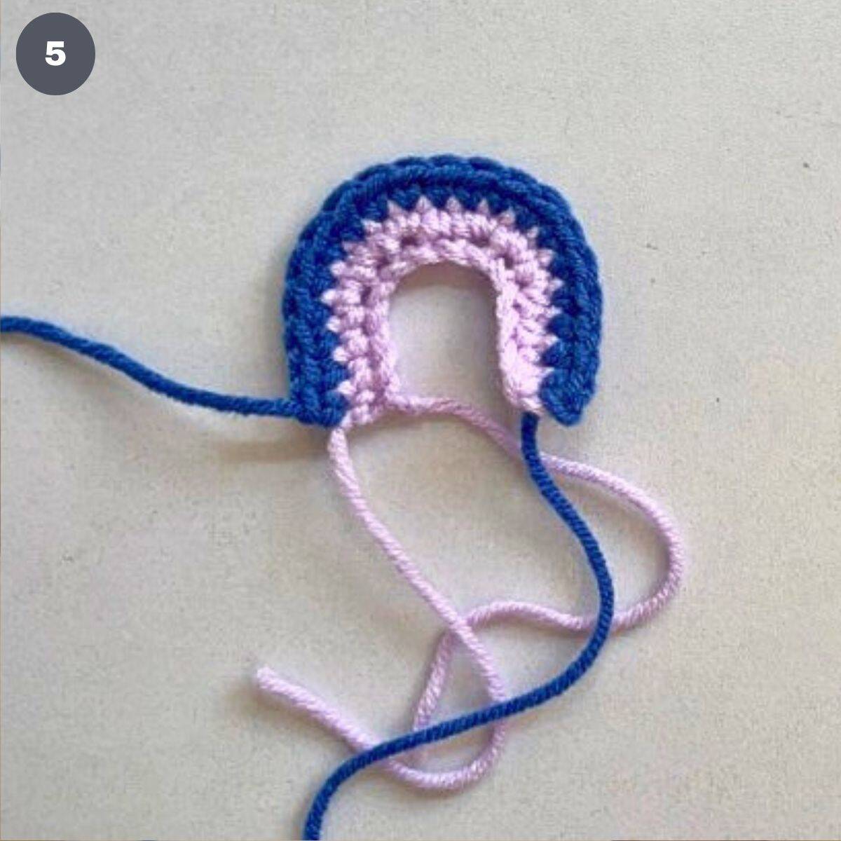 A semi circle crochet made using 2 different colors.