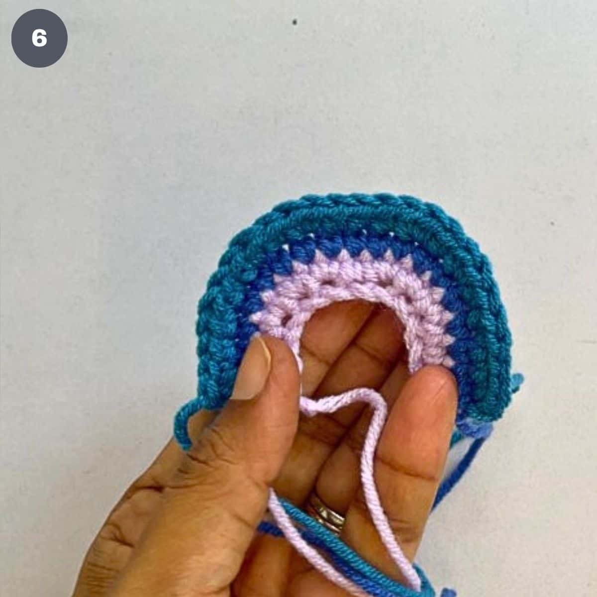 A crochet rainbow made using 3 colors of yarn.