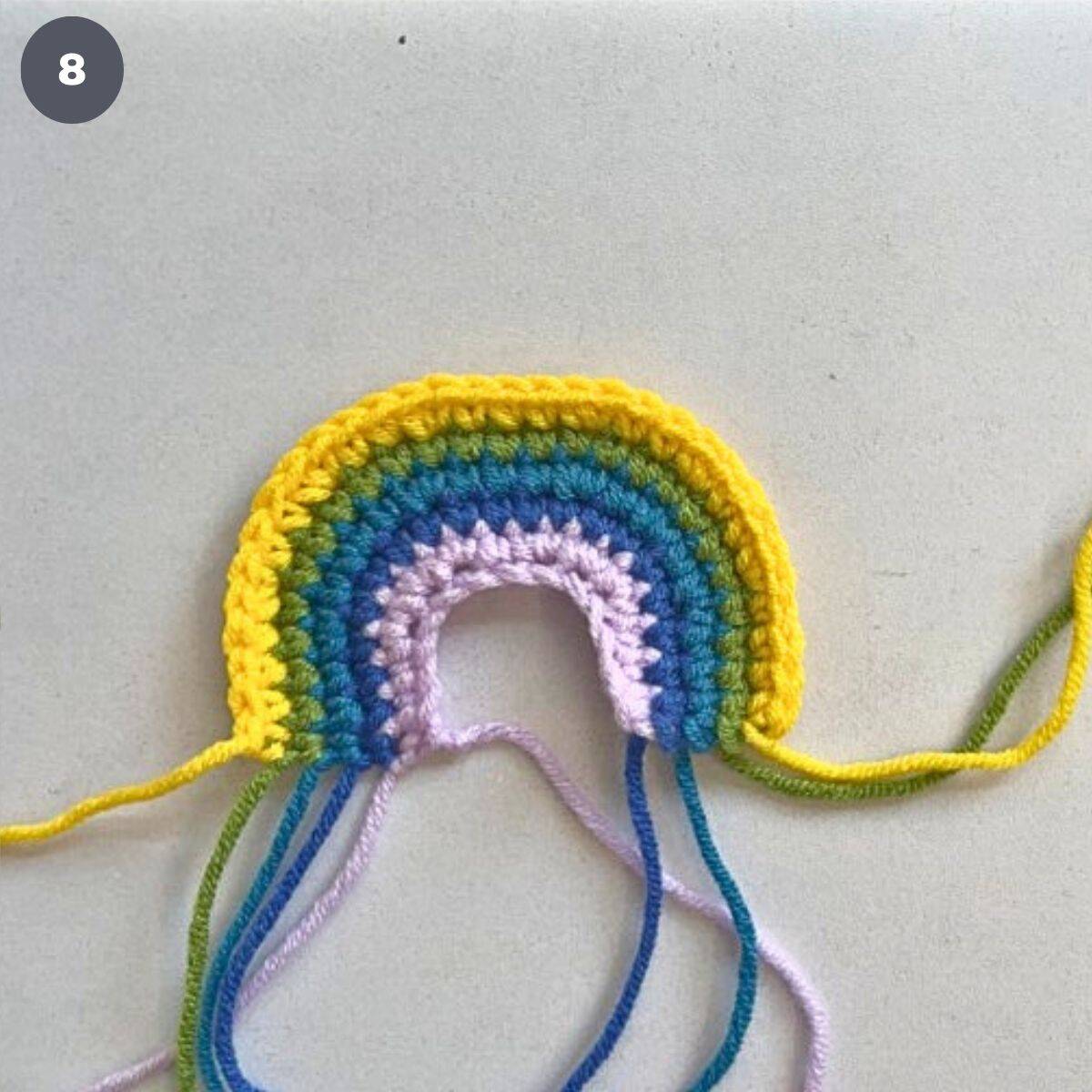 A crochet rainbow made using 5 colors of yarn.