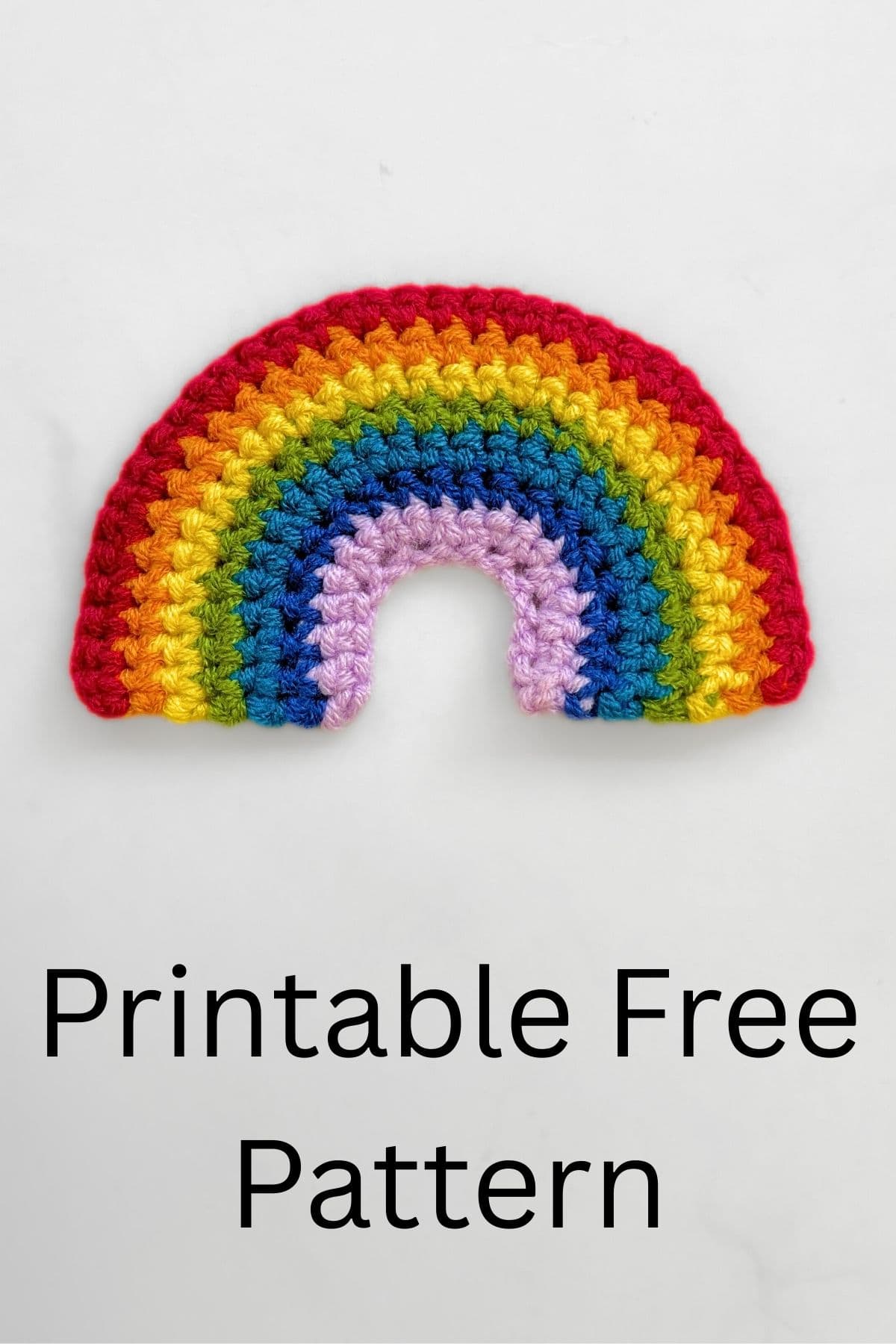 Crochet rainbow against white background.